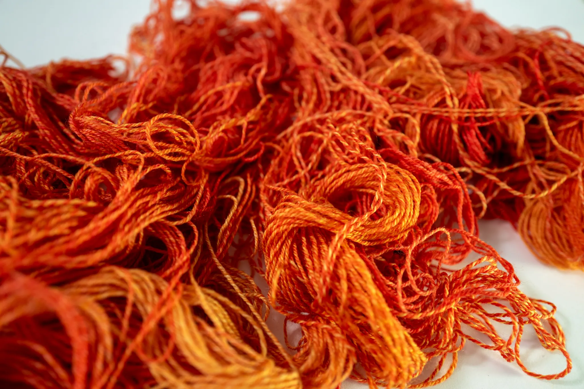 branding photoshoot image of tangled orange yarn