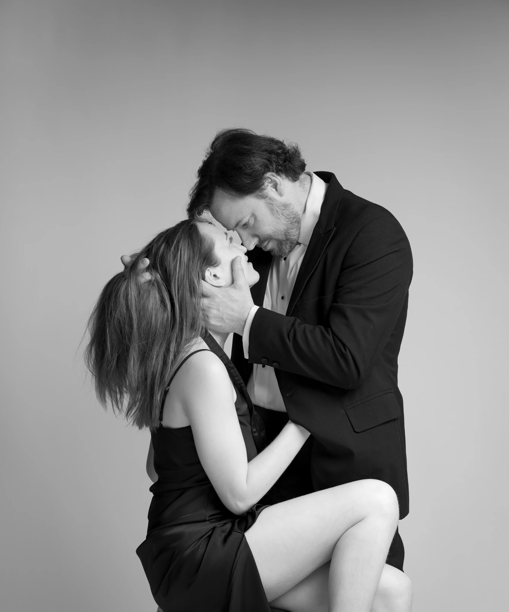 black and white richmond studio photo of engaged couple looking at each other