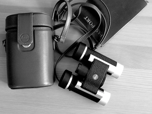 B&W leica binoculars on wooden table