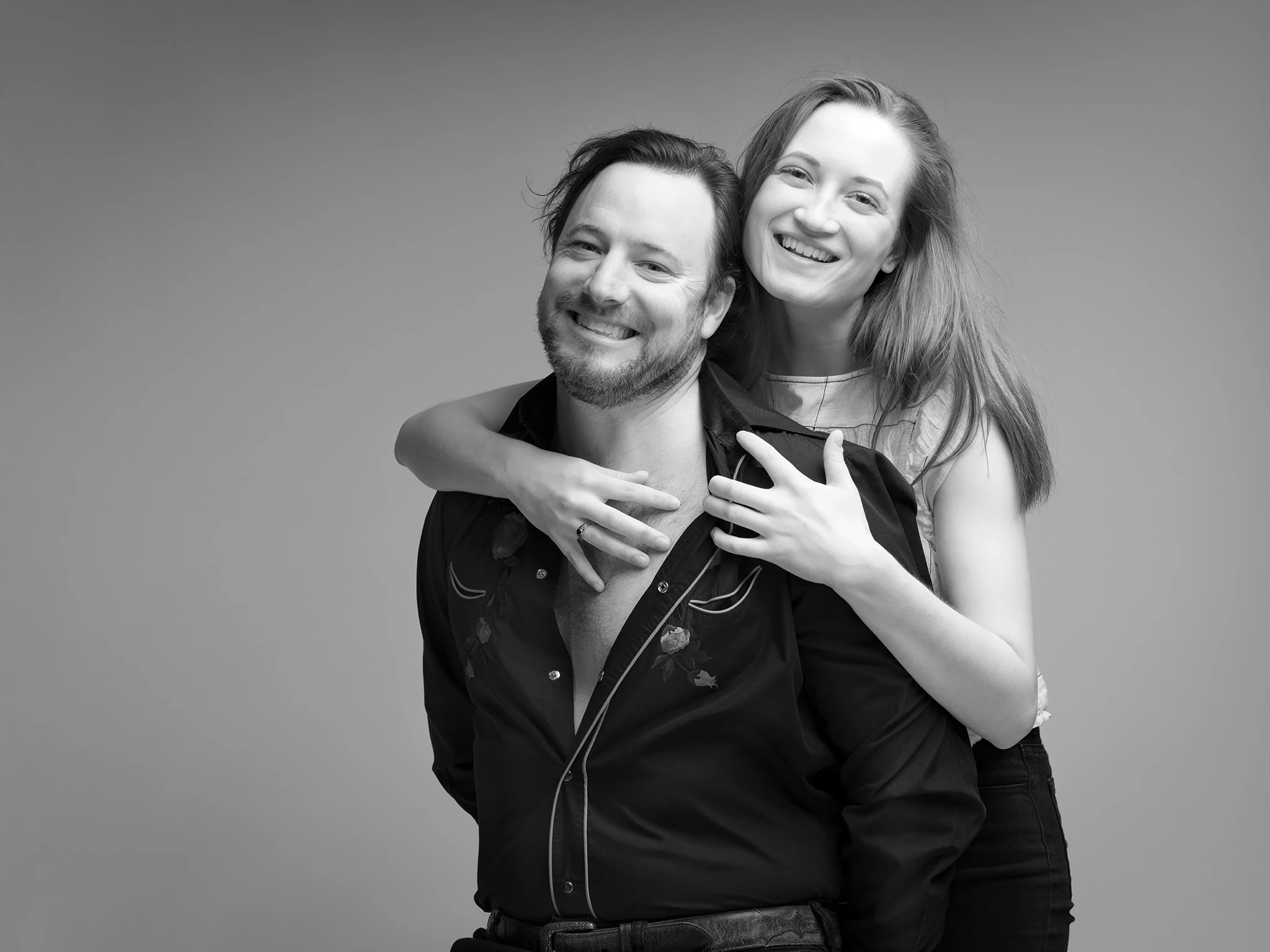 Black and white engagement photo of couple smiling Richmond VA